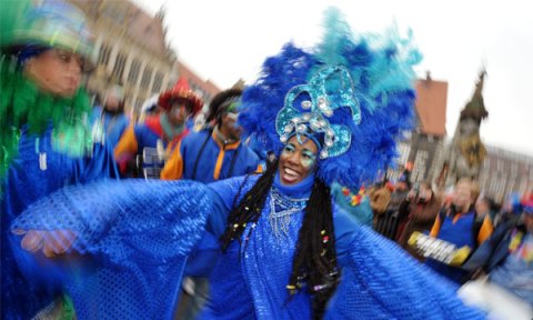 Tanzende Frau im blauen Kostüm beim Karneval.